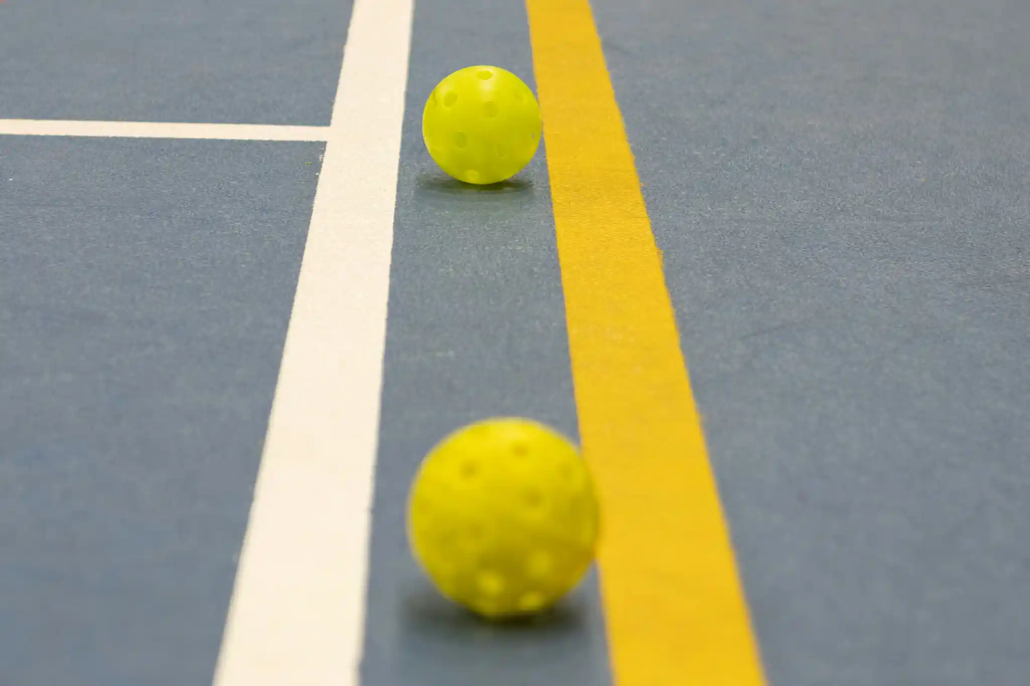 Indoor pickleball court line painting with bright boundary lines for improved gameplay visibility and safer play.