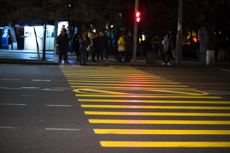 Yellow pedestrian crossing markings at night.