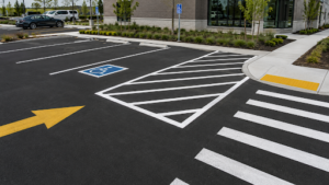 Crosshatched accessible parking area with a pedestrian crossing and curb ramp