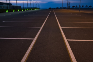 Empty parking lot with white lines at dusk