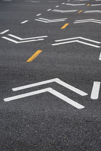 White chevron markings on asphalt.